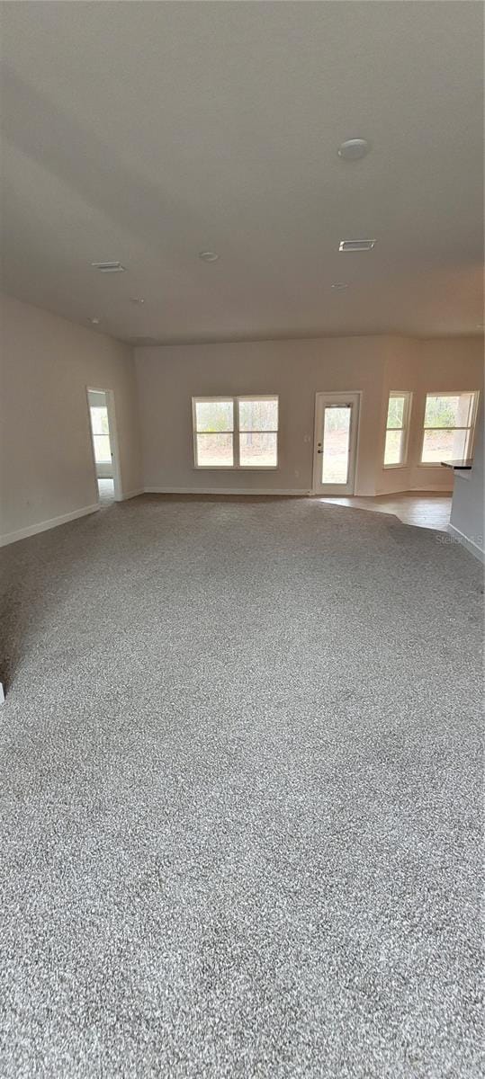 empty room featuring plenty of natural light and speckled floor