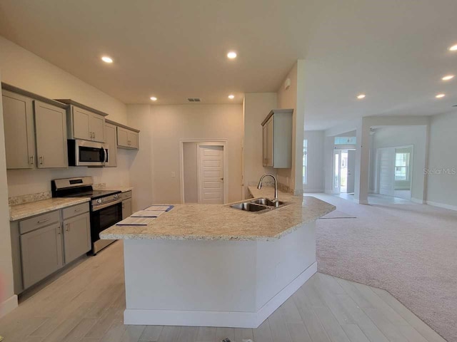 kitchen featuring a sink, light countertops, gray cabinets, and stainless steel appliances