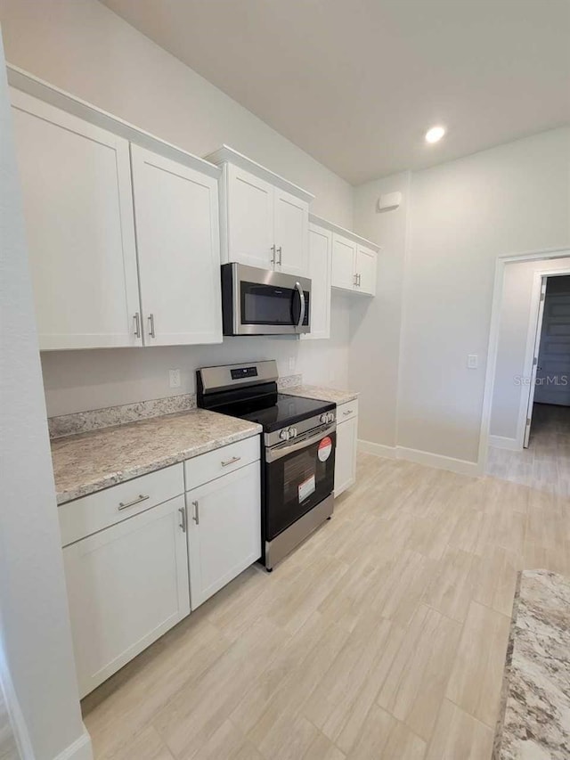 11610 SW 59th Ter, Ocala, FL 34476 - kitchen with appliances with stainless steel finishes, white cabinets, recessed lighting, and light wood-style floors