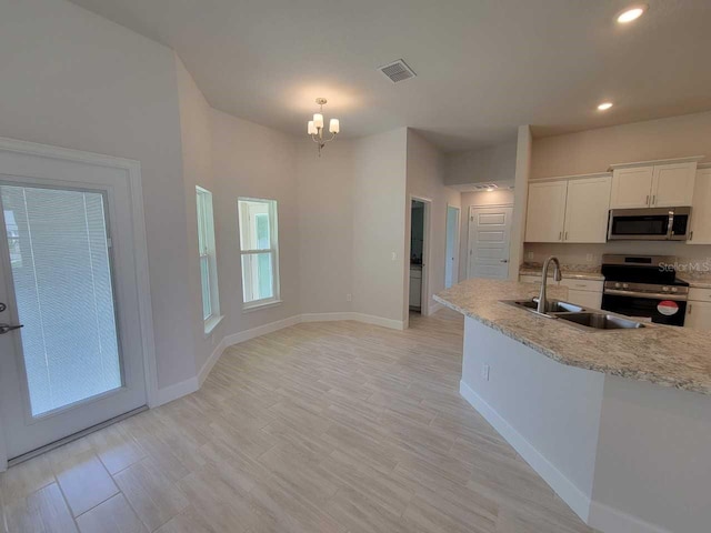 11610 SW 59th Ter, Ocala, FL 34476 - kitchen featuring appliances with stainless steel finishes, recessed lighting, white cabinetry, a chandelier, and light wood-type flooring
