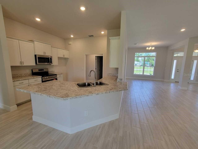 11610 SW 59th Ter, Ocala, FL 34476 - kitchen with appliances with stainless steel finishes, white cabinetry, light wood-type flooring, a peninsula, and recessed lighting