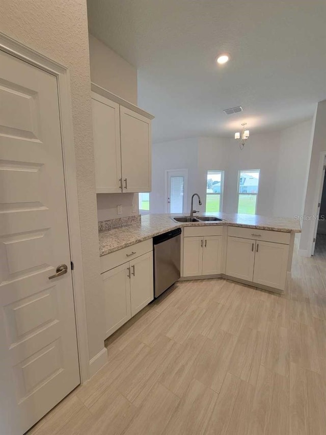 11610 SW 59th Ter, Ocala, FL 34476 - kitchen with stainless steel dishwasher, a peninsula, light wood-type flooring, white cabinetry, and recessed lighting