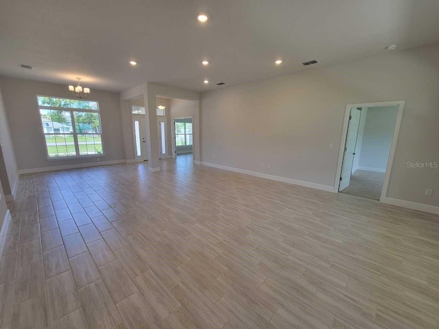 11610 SW 59th Ter, Ocala, FL 34476 - unfurnished living room featuring a chandelier, light wood-type flooring, and recessed lighting