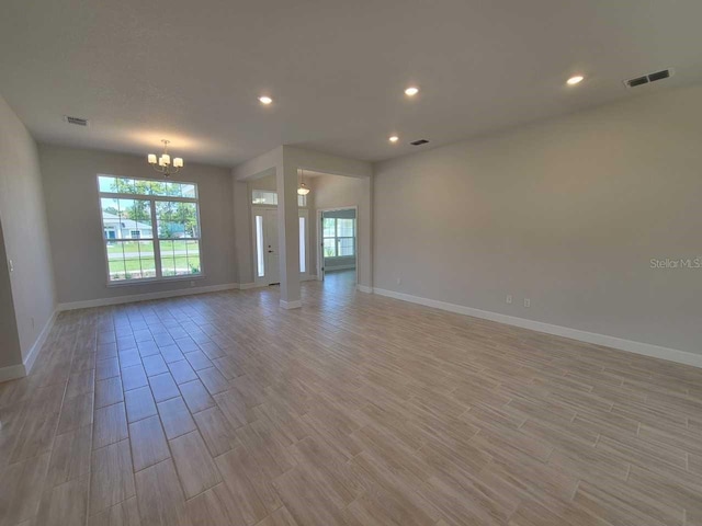 11610 SW 59th Ter, Ocala, FL 34476 - empty room with healthy amount of natural light, a chandelier, light wood finished floors, and recessed lighting