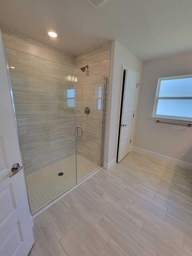 11610 SW 59th Ter, Ocala, FL 34476 - bathroom with a stall shower, wood finished floors, recessed lighting, and a textured ceiling