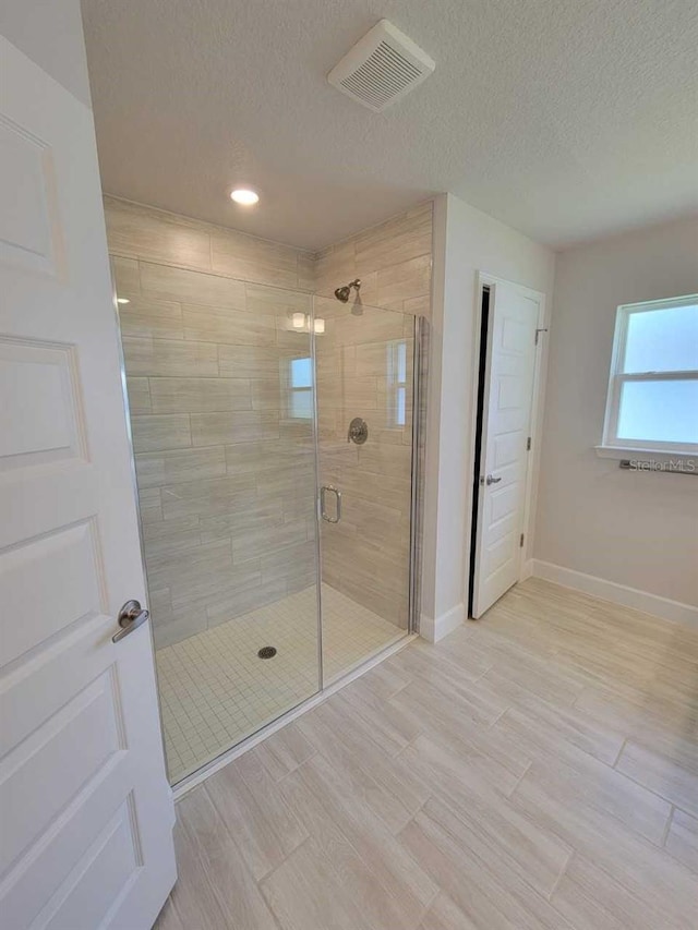 11610 SW 59th Ter, Ocala, FL 34476 - bathroom featuring a stall shower, wood finished floors, a textured ceiling, and recessed lighting