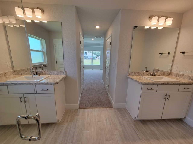 11610 SW 59th Ter, Ocala, FL 34476 - bathroom with healthy amount of natural light, two vanities, wood finished floors, and recessed lighting