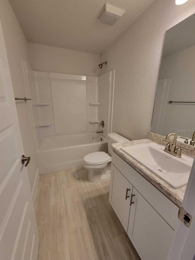 11610 SW 59th Ter, Ocala, FL 34476 - full bathroom featuring vanity, tub / shower combination, wood finished floors, and a textured wall