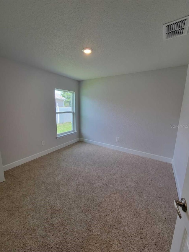 11610 SW 59th Ter, Ocala, FL 34476 - unfurnished room with carpet flooring, a textured ceiling, and recessed lighting