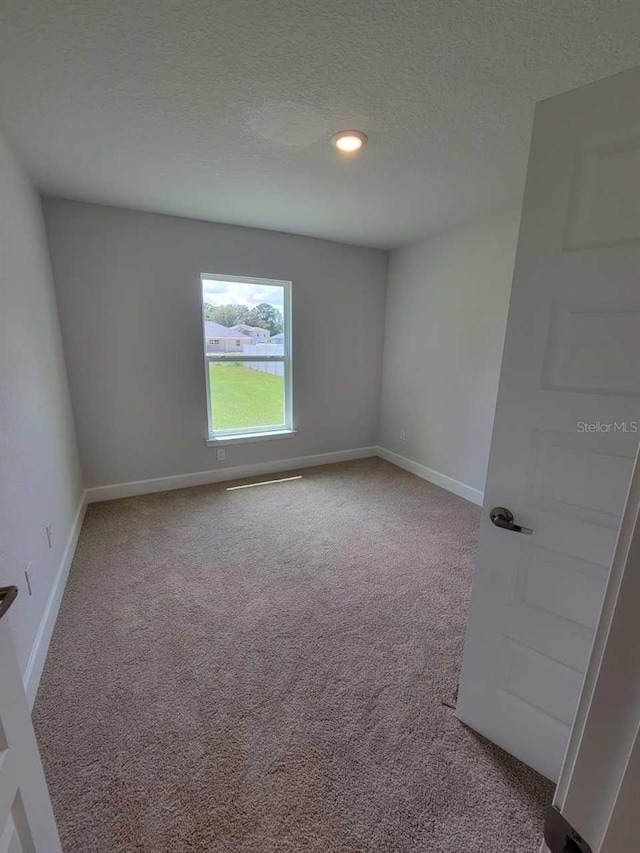 11610 SW 59th Ter, Ocala, FL 34476 - spare room with carpet, a textured ceiling, and recessed lighting
