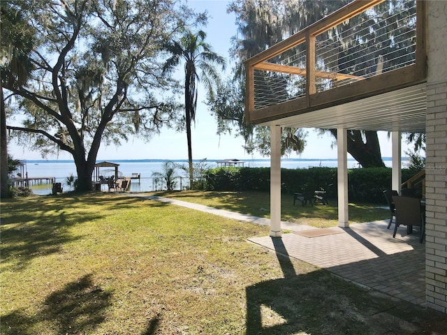 view of yard featuring a patio area and a water view