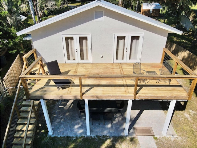 back of property with a wooden deck and french doors