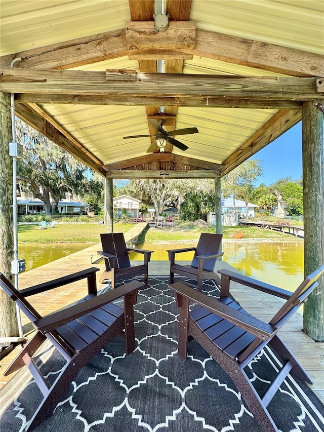 view of patio / terrace featuring ceiling fan and a water view