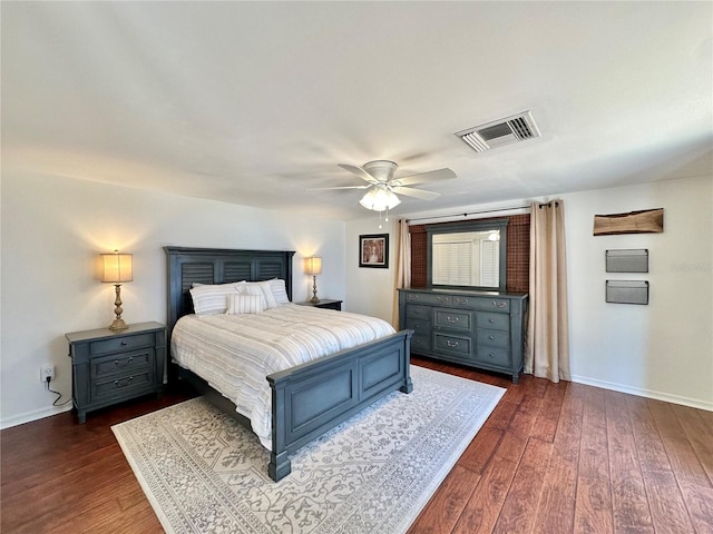 bedroom with ceiling fan and dark wood-type flooring