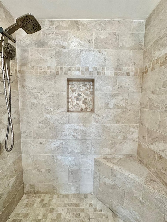 bathroom with tiled shower