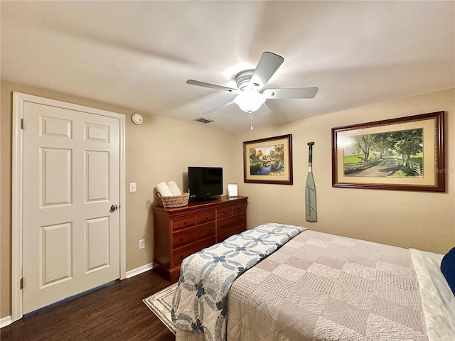 bedroom with ceiling fan and dark hardwood / wood-style floors