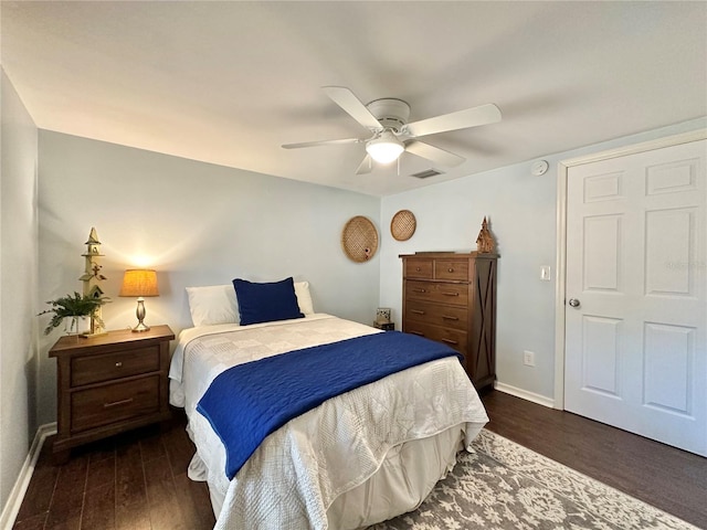 bedroom with ceiling fan and dark wood-type flooring