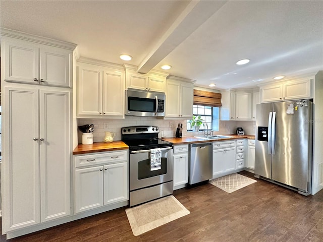 kitchen featuring dark hardwood / wood-style floors, white cabinetry, butcher block counters, and appliances with stainless steel finishes