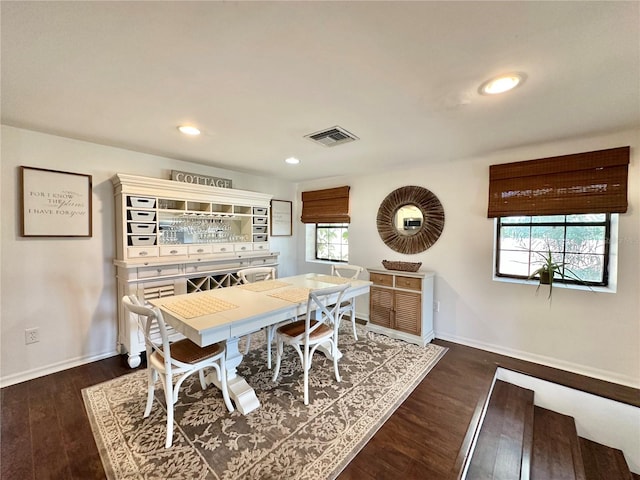 dining room with dark hardwood / wood-style flooring and plenty of natural light