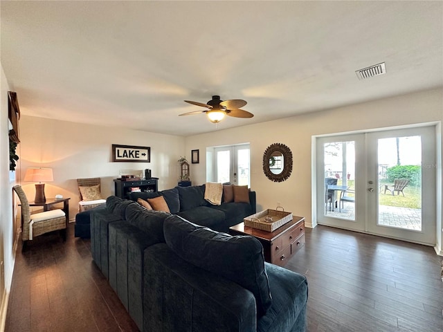 living room featuring ceiling fan, dark wood-type flooring, and french doors