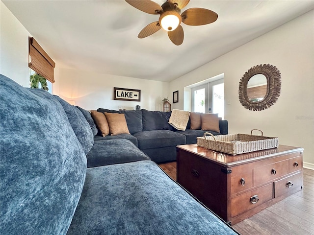 living room with ceiling fan, dark wood-type flooring, and french doors