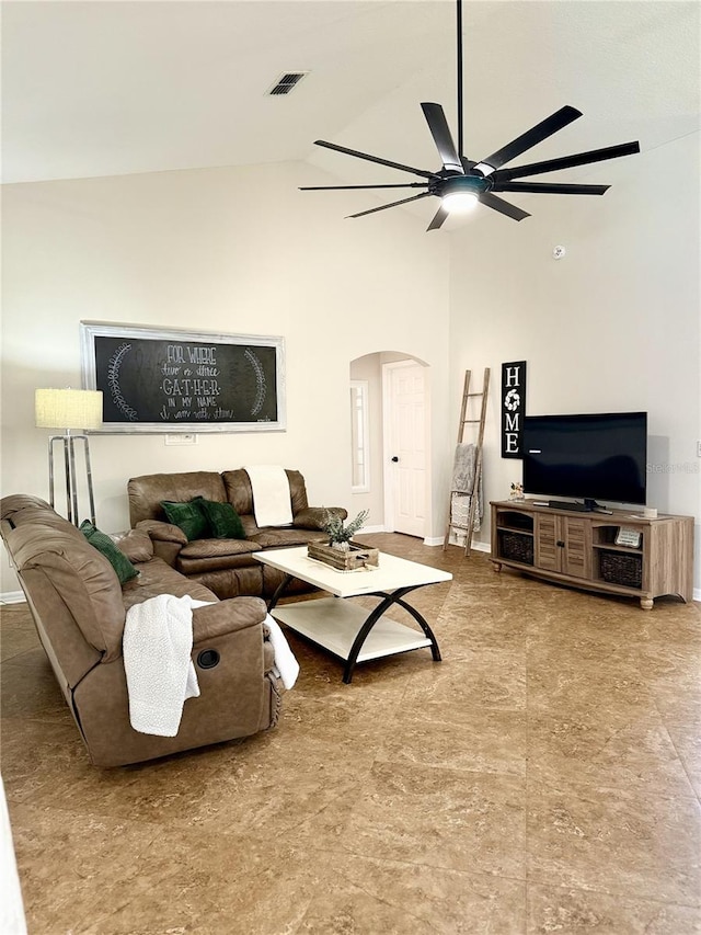 living room featuring ceiling fan and high vaulted ceiling