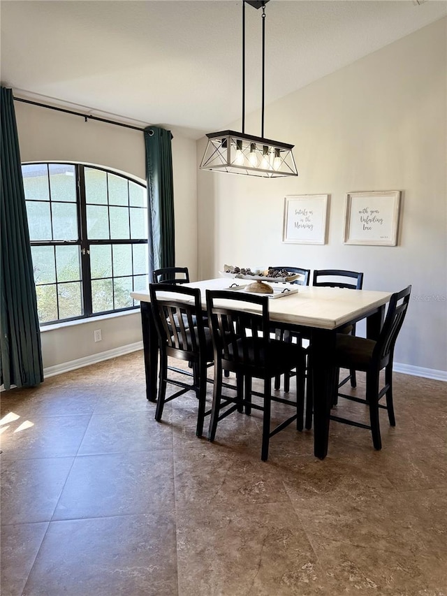 dining room with lofted ceiling