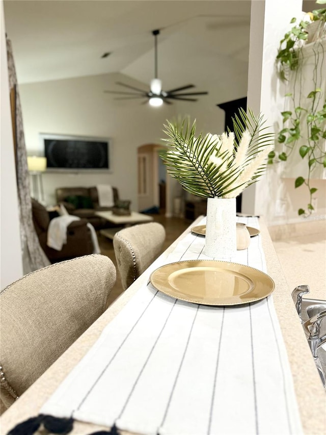 dining area featuring ceiling fan and lofted ceiling