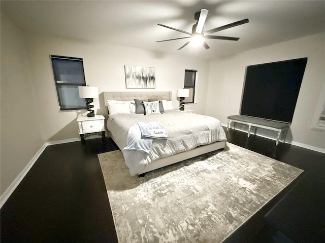 bedroom with ceiling fan and dark wood-type flooring