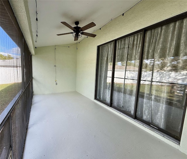 unfurnished sunroom with plenty of natural light and ceiling fan