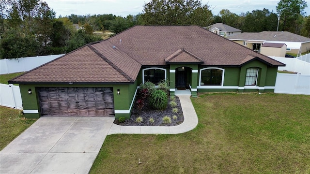 ranch-style home with a garage and a front yard