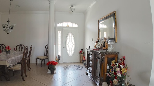 tiled foyer entrance featuring decorative columns and crown molding