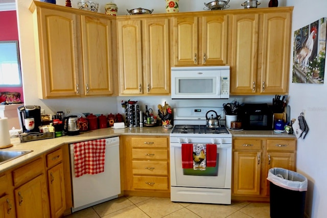 kitchen with light tile patterned flooring and white appliances