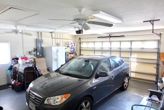 garage with white refrigerator with ice dispenser, electric panel, a garage door opener, and ceiling fan