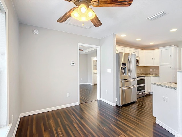 kitchen featuring dark hardwood / wood-style floors, light stone counters, white cabinetry, and stainless steel appliances