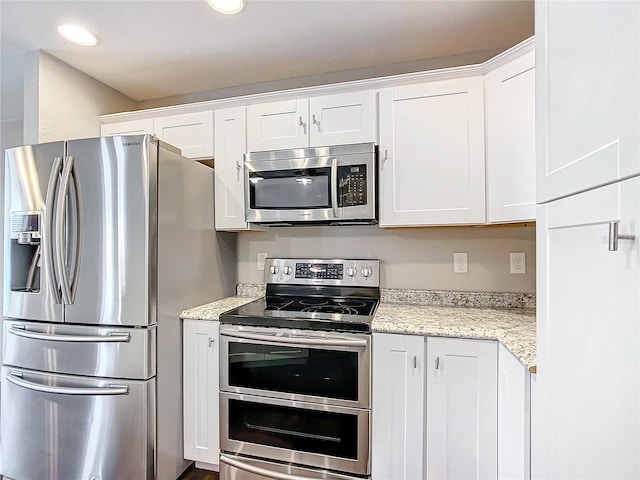 kitchen featuring light stone countertops, white cabinets, and appliances with stainless steel finishes