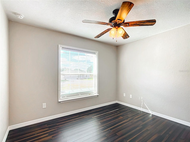 spare room with a textured ceiling, dark hardwood / wood-style flooring, and ceiling fan