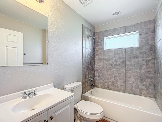 full bathroom with vanity, toilet, and tiled shower / bath