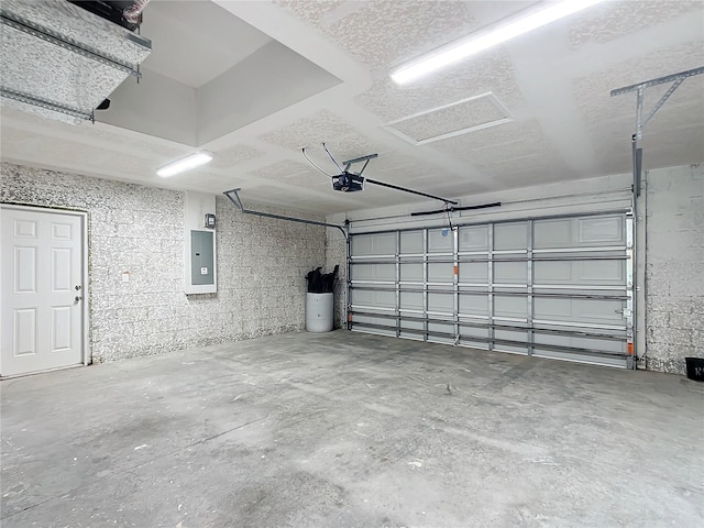 garage with a garage door opener and electric panel