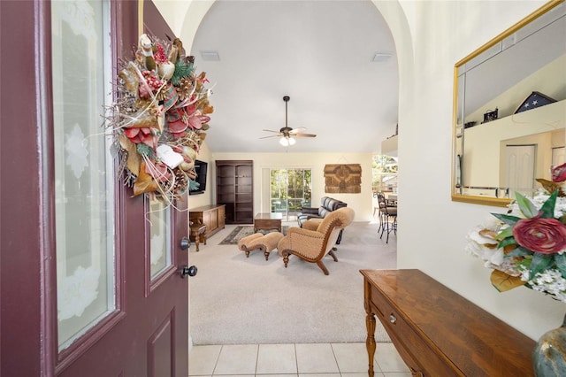 foyer entrance featuring light colored carpet, ceiling fan, and lofted ceiling