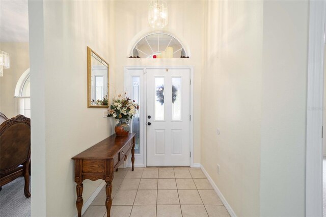 5336 SW 109th Place Rd, Ocala, FL 34476 - entrance foyer with a chandelier, light tile patterned flooring, and baseboards