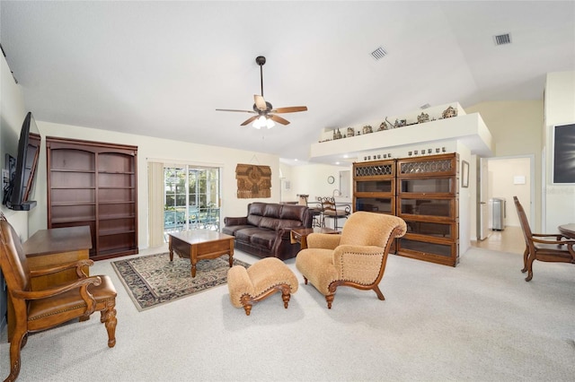 carpeted living room featuring ceiling fan and lofted ceiling