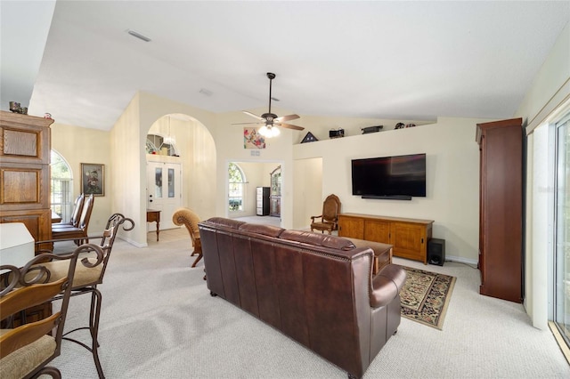 living room featuring ceiling fan, light carpet, and lofted ceiling