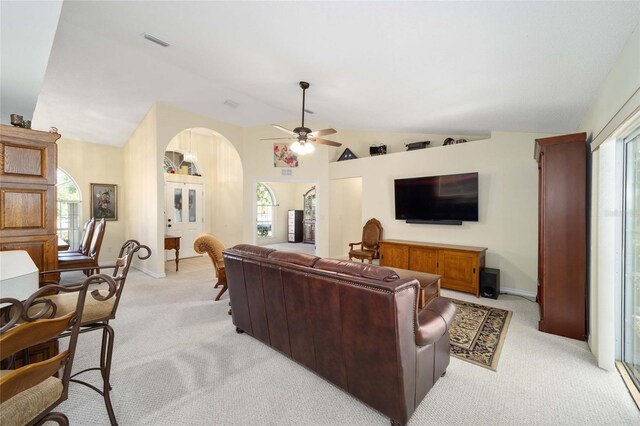 5336 SW 109th Place Rd, Ocala, FL 34476 - living room with arched walkways, light carpet, lofted ceiling, ceiling fan, and baseboards