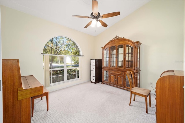 sitting room featuring ceiling fan, high vaulted ceiling, and light colored carpet