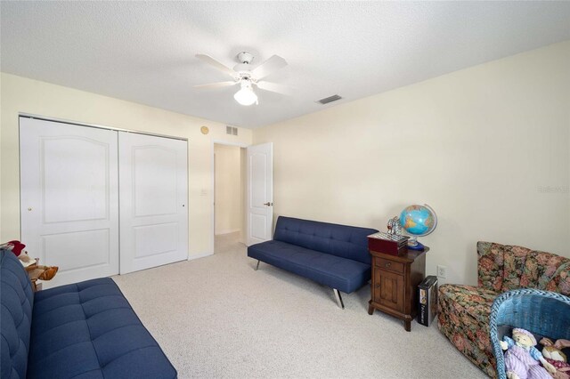 5336 SW 109th Place Rd, Ocala, FL 34476 - living area with light colored carpet, ceiling fan, and a textured ceiling
