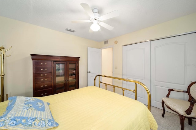 carpeted bedroom with ceiling fan and a closet