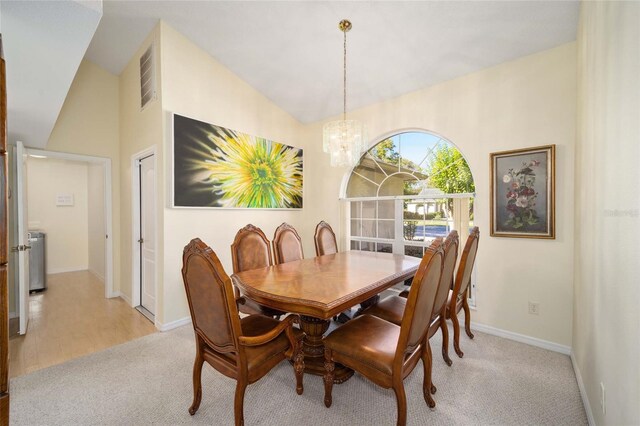 5336 SW 109th Place Rd, Ocala, FL 34476 - dining area featuring light colored carpet, a chandelier, lofted ceiling, and baseboards