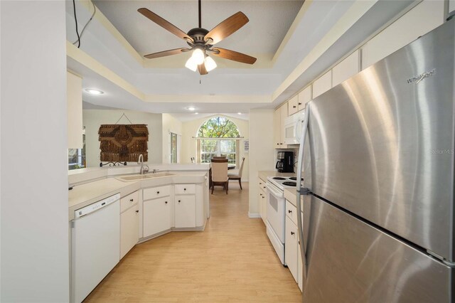 5336 SW 109th Place Rd, Ocala, FL 34476 - kitchen with white appliances, a sink, a peninsula, a raised ceiling, and recessed lighting