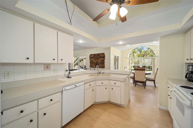 kitchen featuring white cabinets, white appliances, a healthy amount of sunlight, and sink